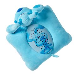 a blue stuffed animal on top of a pillow