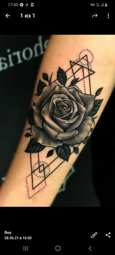 a black and white rose tattoo on the right arm, with geometric shapes around it