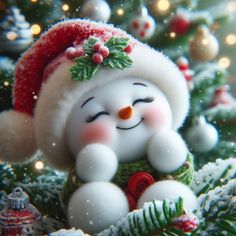 a snowman figurine sitting on top of a christmas tree