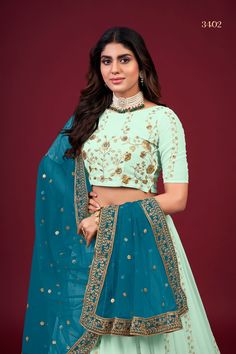 This Green Faux Georgette Lehenga Choli Set with Dupatta is adorned with intricate Zari, Thread & Sequins Embroidery, giving it a timeless and classic look. It includes a 3.5 Meter-long lehenga, a blouse with Regular Sleeves and a 2.30 Meter-long dupatta. The fabric is extra-soft and can be customized to your measurements. Washing instructions: Dry Clean. No of Set - 3-piece set Color- Green Lehenga Choli Fabric - Faux Georgette Stitch Type - Semi-Stitched (Standard Cancan & Canvas Attached) Fla Pista Green Wedding Sets With Unstitched Blouse, Pista Green Wedding Set With Unstitched Blouse, Wedding Set With Unstitched Pista Green Blouse, Pista Green Sets For Diwali Reception, Festive Embroidered Georgette Lehenga, Festive Pista Green Lehenga With Unstitched Blouse, Pista Green Lehenga With Unstitched Blouse For Festive Occasions, Pista Green Semi-stitched Lehenga, Pista Green Embroidered Fabric For Festive Occasion