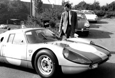 a man standing next to a sports car