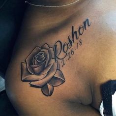 a woman's stomach with a rose tattoo on it and the name rohon written in cursive font