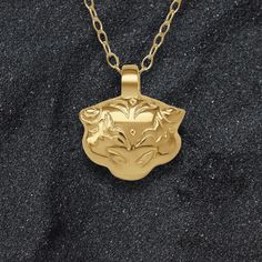 Gold Tiger charm pendant and chain. Please allow me up to 28 days to finish making this piece. An elegant little, double sided, solid gold version of one of my best loved pieces. Designed to complement more refined outfits, from garden party dresses to sophisticated eveningwear. This piece is made from .375 nine carat gold and is supplied on a 45cm (18 inch) long, 1.2mm wide solid gold chain. This charm measures 1.3cm wide, which is 0.51 inches. Wearing a piece of Adrian Ashley’s jewellery identifies you as someone who can appreciate handmade goods and fine craftmanship. I do my best to insure all the raw materials I use have been sourced responsibly and I always price my work honestly. All pieces are handmade in a small workshop in the English countryside and shipped to collectors across Elegant Gold Plated Charm Necklace With Large Pendant, Elegant Recycled Gold Pendant Charm Necklace, Elegant Brass Charm Necklace With Large Pendant, Luxury 14k Gold Tarnish-resistant Charm Necklace, Luxury Gold Plated Charm Necklace, Tarnish Resistant, Garden Party Dresses, Luxury Gold-tone Tarnish Resistant Charm Necklaces, Yellow Gold Zodiac Sign Amulet Necklace, Gold Tiger