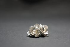 -Product description- Handmade sterling silver (925) jasmine earrings. The inner surface of the petal was carefully hand textured to be shimmery. While the outer layer was smooth and shiny, to give a beautiful contrast. A freshwater pearl was then attached to give an elegant touch. Great as a gift for her, or a treat for yourself. It is about 17mm (11/16 inch) in diameter, weighing 3.3 g (0.12oz). The ear post is 11mm(7/16 inch). Ear post can be customized to ear wire upon request. Please feel f Silver Pearl Drop Flower-shaped Earrings, Silver Petal-shaped Earrings For Gift, Silver Sterling Earrings With 3d Flowers, Sterling Silver Earrings With 3d Flowers, Handmade Silver Flower Pearl Earrings, Silver Petal Flower Earrings For Gift, Sterling Silver Flower Earrings With Pearl Drop, Silver Flower-shaped Pearl Earrings, Silver Pearl Drop Earrings In Flower Shape