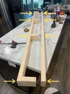 the kitchen counter is being worked on with wood and marble workbench in place