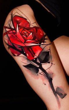 a woman's thigh with a rose tattoo on it