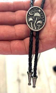 This awesome bolo features a mushroom design. It is solid stainless steel metal, handcrafted by our design team. Quality guaranteed, picture does not do this bolo justice! The piece measures 1 1/2'' x 1 1/4''. It can adjust lengths, 39'' in total length. We have matching belt buckles to pair! Handmade Sterling Silver Bolo Tie As Gift, Adjustable Sterling Silver Bolo Tie For Gifts, Handmade Adjustable Bolo Ties For Festivals, Unique Adjustable Bolo Ties For Gifts, Unique Adjustable Bolo Tie For Gift, Unique Silver Bolo Tie For Gift, Unique Silver Bolo Tie As A Gift, Unique Silver Bolo Ties For Gift, Unique Silver Bolo Ties As Gift