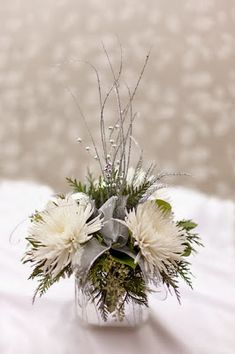 a vase filled with white flowers on top of a table