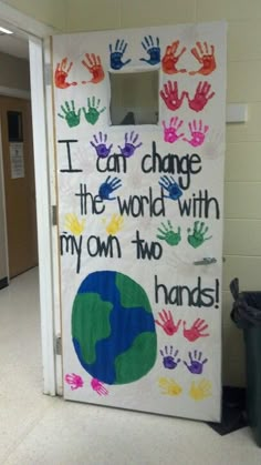 a door decorated with hand prints and the words i can change the world with my own two hands