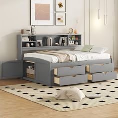 a bedroom with a bed, bookcases and drawers on the floor next to a rug