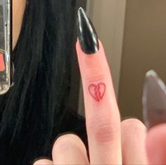 a woman's finger with a heart drawn on it and a ring in the middle