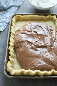 there is a pie with chocolate frosting in the pan