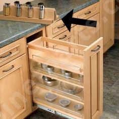 an open drawer in the middle of a kitchen