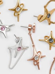 Level up your accessory game with these unique mismatched drop earrings. In a sweet rose gold-toned hue, these earrings come set with silver crystals in the middle of each star for an eye-catching shine. Featuring dainty drop chains and a U-shaped chain-link stud design, they will add sparkle and captivate with your every movement. Star Crystal, Stud Design, Mismatched Earrings, Charles Keith, Gold Drop Earrings, Rose Gold Earrings, Black Crystals, Level Up, Chain Link