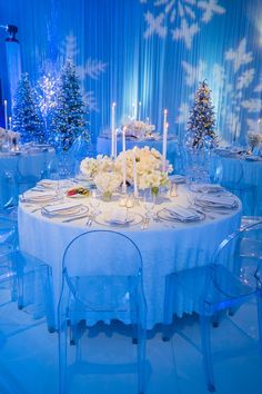 a table set up with white flowers and candles for an elegant winter wedding reception at the four seasons hotel