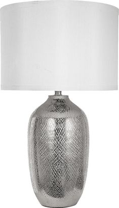 a silver table lamp with a white shade on the base and a light in front of it