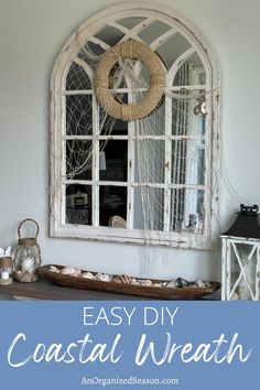 an easy diy coastal wreath is displayed on the wall in front of a window