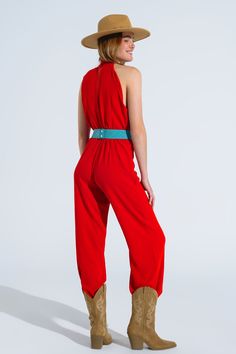 Turn heads with our stunning Red Jumpsuit With Crossed Halter Neckline. Crafted from 100% polyester, this jumpsuit offers a lightweight and comfortable fit, making it perfect for spring and summer events. The jumpsuit features a chic halter neckline that crosses at the top, adding a unique and elegant touch. The wide legs create a flattering silhouette, while the small gap at the stomach adds a modern and stylish flair. The high waist design accentuates your figure, and it can be styled with a belt for an even more defined waistline (belt not included). Key Features: Material: 100% Polyester Fit: Runs true to size, regular fit Details: High collar neckline, sleeveless style, wide leg, high waist, flattering gap at the stomach, zip-back fastening, lightweight woven fabric Model Info: Wearin Style For Spring, Tan Scarf, Beautiful Jumpsuits, Skirt Jumpsuit, Red Jumpsuit, Style Party, Scarf Headband, Knitwear Tops, Romper Pants