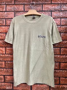 "Vintage 90s Vision Street Wear Embroidery Logo Skate T Shirt / 90s Streetwear / Thrasher Skates T Shirt Made In Usa Size L Condition : Good Used Size on tag : L but fit M Colour : Grey Brand : Vision street wear Measurement : Armpit to armpit - 19.5\" Length - 28\" Material : Cotton Made In: USA THE SHIPPING (Your Choice Please read) 1. The shipping cost is USD 20 via Malaysian Registered Postage With Tracking Number. It will take 2-4 weeks or more for delivery, depends on your custom checking. 90s Cotton Tops With Embroidered Graphics, 90s Embroidered Cotton Tops, Embroidered Green Tops For Streetwear, 90s Embroidered Top For Streetwear, Vintage Embroidered Crew Neck T-shirt, Vintage Embroidered Cotton T-shirt, Thrasher Skate, Brand Vision, Vision Street Wear