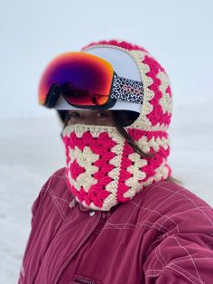 a person wearing ski goggles and a crocheted hat