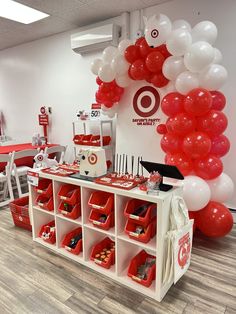 a room filled with lots of red and white balloons