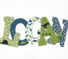 the letters are made out of fabric and have dinosaurs on them