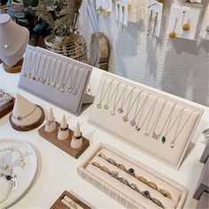 a table topped with lots of jewelry on display