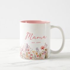 a white and pink coffee mug with the name mama printed on it