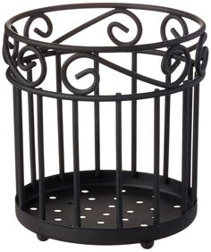 a black metal basket with decorative designs on it