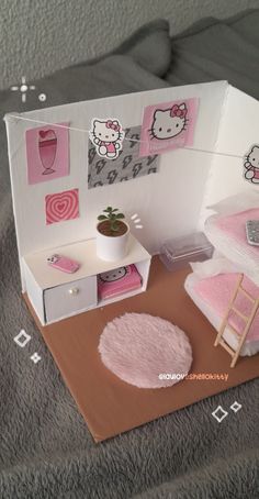 a hello kitty dollhouse with furniture and accessories on the floor, including a bed