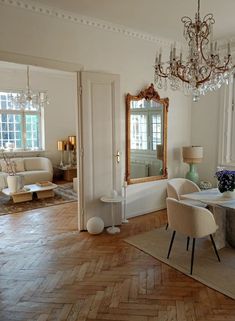 a dining room table with chairs and a chandelier