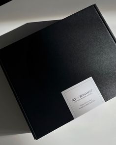 a black book with a white label on the front and back cover is laying open