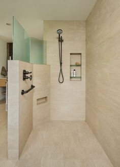 a walk in shower sitting inside of a bathroom