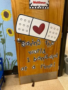 a wooden door with writing on it that says saving the world 1 bandad at a time