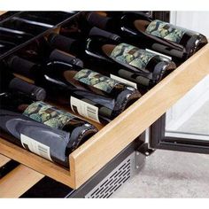 several bottles of wine are sitting in the drawer