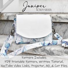 a white purse sitting on top of a marble bench