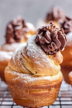 chocolate frosted cupcakes with powdered sugar on top