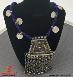 * This handmade Afghani Kuchi style Necklace is a magnificent piece of art as it carries all the elements which make this ethnic ornament authentic traditional wear. * This necklace has intricately carved designs and multicolor stones carved into the pendent making the ornament more ravishing and tempting. * The lower part of the artifact has been embellished with silver dangling beads connected to the pendant with long chains. Not only that the blue beads rolled around the thread has complement November Birthstone Necklace, Boho Cuff Bracelet, Hand Cuff Bracelet, Porcelain Necklace, Boho Cuff, Afghan Jewelry, Headpiece Jewelry, Topaz Pendant, Topaz Necklace