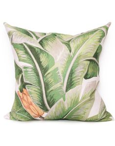 a green and white pillow with banana leaves on it's side, in front of a white background