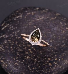 Pear shaped Smoky Quartz engagement ring, Rose gold wedding ring, vintage milgrain moissanite halo unique art deco anniversary Bridal ring Back to Belloring shop: https://www.etsy.com/shop/BrilliantRing?ref=l2-shopheader-name ---------------------------Specifications---------------------- Engagement ring Center Stone - 6*9mm Smoky Quartz Side stones - 0.323ct Moissanite or Diamond ---------------------------DIMENSIONS----------------------- The Width of the Band - 1.5mm The Thickness of the Band Smoky Engagement Ring, Moody Engagement Ring, Brown Wedding Ring, Brown Engagement Ring, Smoky Quartz Wedding Ring, Smoky Quartz Gold Engagement Ring, Brown Engagement Rings, Vintage Wedding Rings Rose Gold, Smoky Quartz Engagement Ring