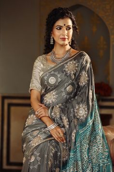 Gorgeous dark grey tussar georgette saree is a perfect choice for weddings and festive occasions!. It has a contrasting green pallu and comes with a beautiful embroidered blouse. Disclaimer: The actual product may vary slightly from the image. These are custom orders, hence expect slight variation in color, placement of the motif or buta. ESTIMATED DELIVERYBecause this is a custom order, it would take about 4 weeks from the date of purchase. RETURN POLICYThis product is a custom order and cannot be returned or exchanged. Grey Saree Contrast Blouse, Bollywood Style Gray Semi-stitched Traditional Wear, Gray Traditional Wear For Festive Occasions, Gray Festive Traditional Wear, Festive Gray Traditional Wear, Semi-stitched Gray Traditional Wear With Zari Work, Gray Traditional Wear With Pallu, Traditional Gray Wear With Pallu, Gray Chanderi Traditional Wear For Festive Occasions