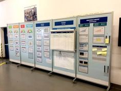 a group of blue and white bulletin boards sitting next to each other in a room