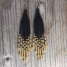 Native American earrings. Arrow pattern including seed beads in matte and metallic with warm colors black and gold. These earrings measure 3 1/2 inches with your choice of ear wires. If you want a custom order :  contact me . Each of my creations is inspired by nature . Thank you and happy ! Black Beaded Earrings With Round Beads And Fringe, Black Beaded Fringe Earrings With Round Beads, Gold Beaded Fringe Earrings With Adjustable Fit, Gold Dangle Earrings With Black Beads, Gold Beaded Earrings With Fringe, Black Beaded Tassel Earrings With Round Beads, Adjustable Gold Beaded Earrings With Black Beads, Black Fringe Earrings With Round Beads, Adjustable Black Beaded Tassel Earrings