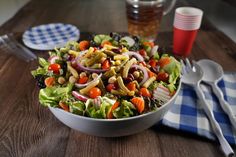 a salad with beans, carrots, onions and lettuce