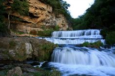 there is a waterfall that has water cascading down it