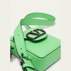 Valentino Garavani "Locò" mini crossbody bag in leather Front V logo hardware Adjustable removable leather shoulder strap; approx. 21.6" drop Zip closure Exterior, one front magnetic flap pocket Interior, one slip pocket Approx. 6.3"H x 4.72"W x 2.36"D Made in Italy Luxury Green Bag With Logo Hardware, Leather Shoulder Bag With Logo Hardware, Leather Rectangular Shoulder Bag With Logo Hardware, Rectangular Leather Shoulder Bag With Logo Hardware, Designer Leather Bag With Logo Strap, Leather Shoulder Bag With Logo Strap For Business, Business Crossbody Shoulder Bag With Logo Hardware, Designer Leather Shoulder Bag With Logo Hardware, Designer Leather Shoulder Bag With Logo Strap