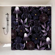 the shower curtain is decorated with purple flowers and leaves on a black background, along with an open shower head