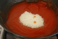 a pot filled with red liquid and white stuff