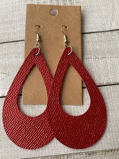 Dimensions: Teardrop w/Window 2 1/2" X 1 1/2" Color: Firm red leather.  Hardware is stainless steel and is nickel and lead free. *Back side or suede back color on this leather mat change from dye kit to dye lot. ** Each piece is unique, so expect slight differences from the piece pictured. Red Leather Earrings For Gifts, Adjustable Red Leather Earrings, Red Leather Jewelry For Gifts, Red Leather Jewelry For Gift, Red Nickel-free Teardrop Earrings, Nickel Free Red Teardrop Earrings, Nickel-free Red Teardrop Earrings, Trendy Red Teardrop Earrings, Leather Teardrop Jewelry