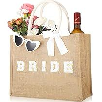 a brown bag with sunglasses and flowers in it that says bride on the side, sitting next to a bottle of wine